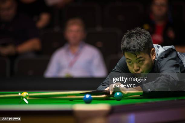 Liang Wenbo of China plays a shot during his first round match against Duane Jones of Wales on day one of 2017 Dafabet English Open at Barnsley...