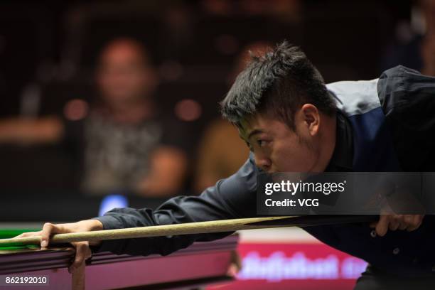 Liang Wenbo of China plays a shot during his first round match against Duane Jones of Wales on day one of 2017 Dafabet English Open at Barnsley...