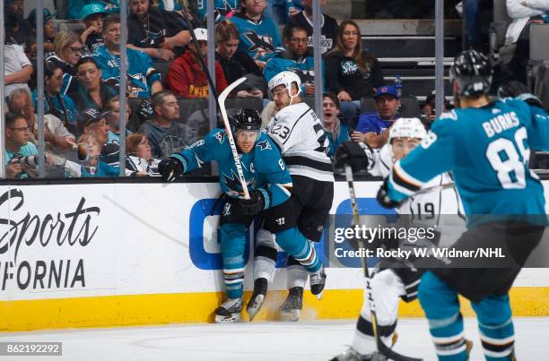 Dustin Brown of the Los Angeles Kings trys to hit Joe Pavelski of the San Jose Sharks at SAP Center on October 7, 2017 in San Jose, California.