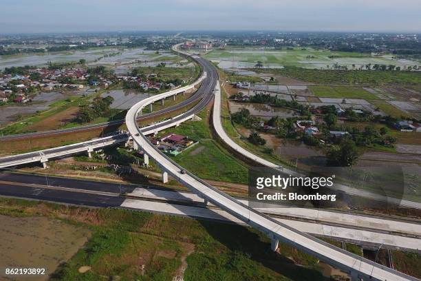 Section of the Medan-Kualanamu-Tebing Tinggi toll road is seen alongside farm land in this aerial photograph taken in Medan, North Sumatra,...
