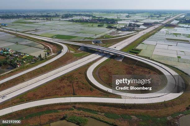 Section of the Medan-Kualanamu-Tebing Tinggi toll road is seen alongside farm land in this aerial photograph taken in Medan, North Sumatra,...