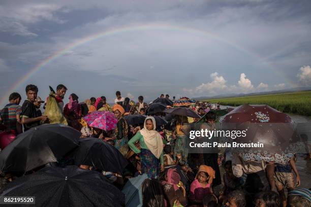Rainbow hovers above thousands of Rohingya refugees fleeing from Myanmar are kept under a tight security by Bangladeshi military after crossing the...