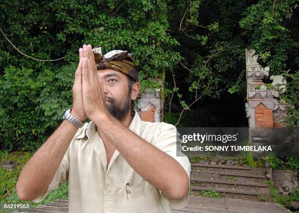 By Presi Mandari A Balinese man prays in front of the gate of a graveyard at Trunyan village in Bangli on the resort island of Bali on March 18,...