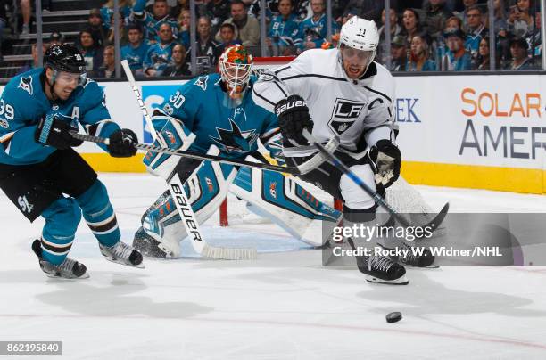 Logan Couture of the San Jose Sharks and Anze Kopitar of the Los Angeles Kings battle for the puck as Aaron Dell of the San Jose Sharks defends at...