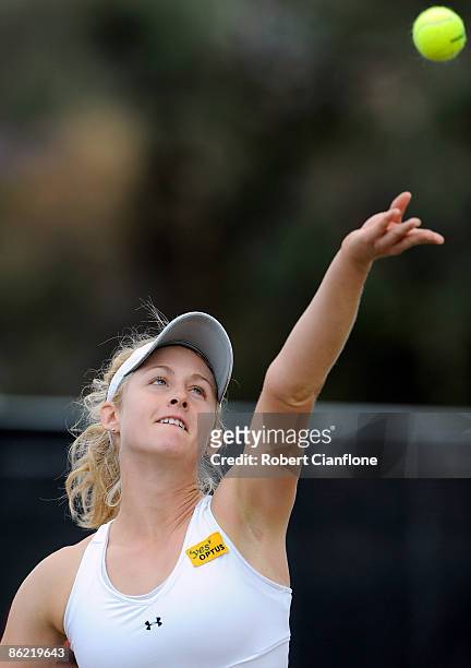 Jessica Moore of Australia serves against Mateja Karlevic of Switzerland during the Federation Cup World Group II Play-off match between Australia...