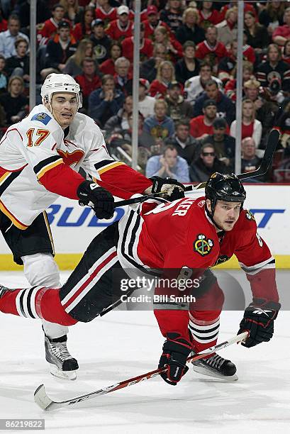 Rene Bourque of the Calgary Flames pushes into Matt Walker of the Chicago Blackhawks during game 5 of the Western Conference Quarterfinals of the...