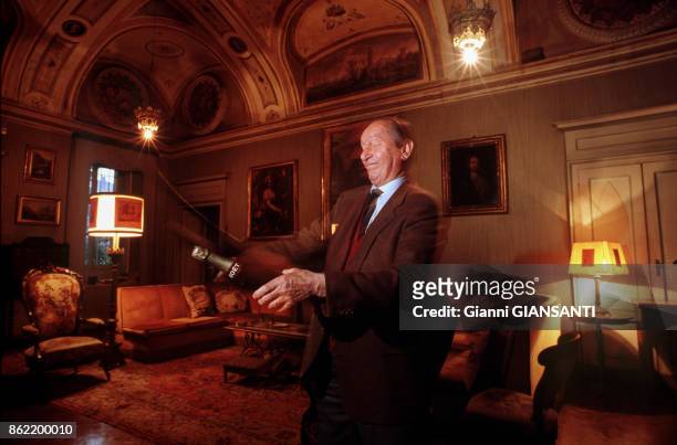 Le Comte Piozzo di Rosigno Vittorio sabrant une bouteille de Champagne dans sa demeure de Turin le 14 avril 1989, Italie.