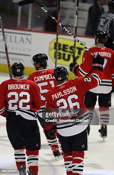 Troy Brouwer Brian Campbell, Samuel Pahlsson and Brent Seabrook of the Chicago Blackhawks raise their sticks to the fans after a win over the Calgary...