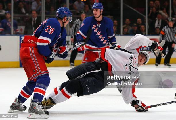 Lauri Korpikoski of the New York Rangers dumps Alex Ovechkin of the Washington Capitals late in Game Four of the Eastern Conference Quarterfinal...
