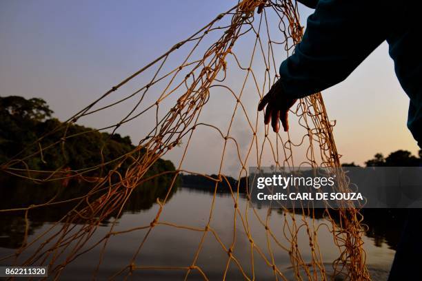 Fisherman Edmilson Ferreira places a net to fish arapaima, also known as pirarucu in the Western Amazon region near Volta do Bucho in the Ituxi...