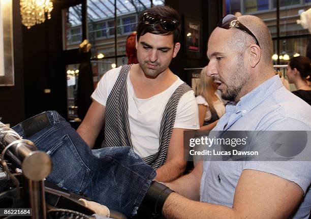 Designer Alex Perry speaks wth one of the V Australia New Generation designers at his store in the Strand Arcade on April 26, 2009 in Sydney,...