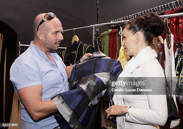 Designer Alex Perry speaks wth one of the V Australia New Generation designers at his store in the Strand Arcade on April 26, 2009 in Sydney,...