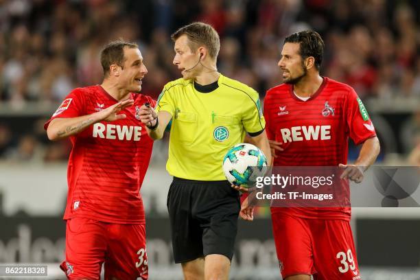 Matthias Lehmann of Koeln and Nikolas Terkelsen Nartey of Koeln speak with Referee Benjamin Cortus diskussion during the Bundesliga match between VfB...