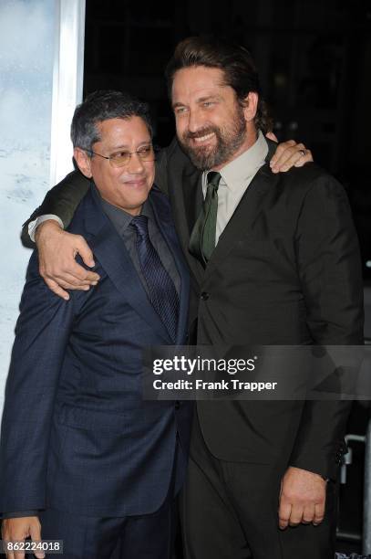 Director Dean Devlin and actor Gerard Butler attend the premiere of Warner Bros. Pictures' "Geostorm" on October 16, 2017 at the TCL Chinese Theater...