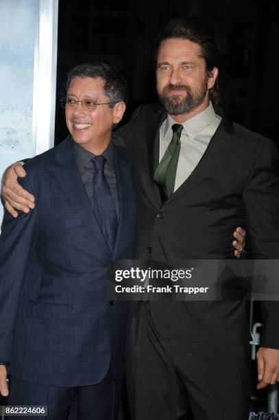 Director Dean Devlin and actor Gerard Butler attend the premiere of Warner Bros. Pictures' "Geostorm" on October 16, 2017 at the TCL Chinese Theater...