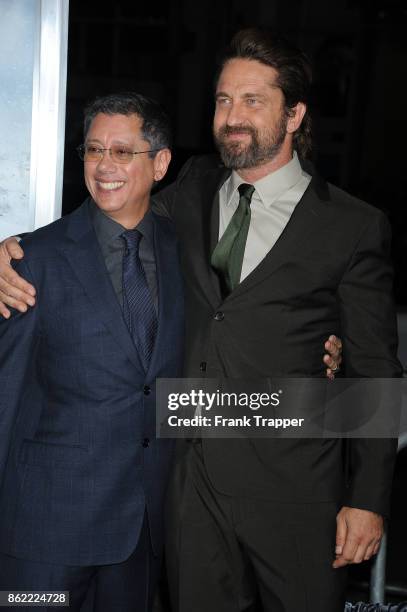 Director Dean Devlin and actor Gerard Butler attend the premiere of Warner Bros. Pictures' "Geostorm" on October 16, 2017 at the TCL Chinese Theater...