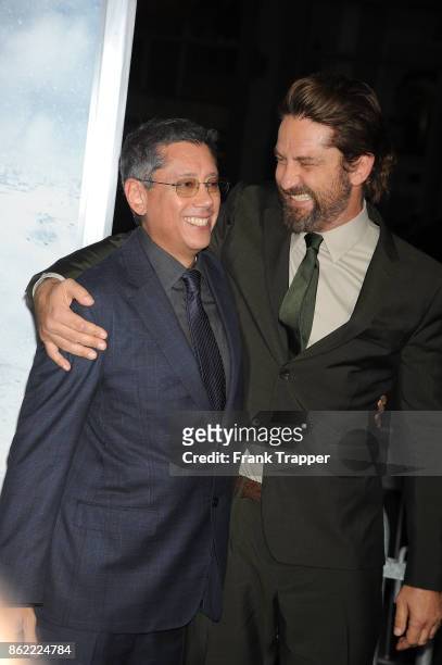 Director Dean Devlin and actor Gerard Butler attend the premiere of Warner Bros. Pictures' "Geostorm" on October 16, 2017 at the TCL Chinese Theater...