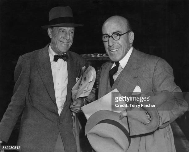 English actors and comedians Ralph Lynn and Robertson Hare arrive at Liverpool Street Station in London on their return from Germany, where they have...