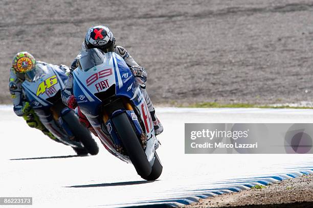 Jorge Lorenzo of Spain and Fiat Yamaha Team lifts the front wheel in front of Valentino Rossi of Italy and Fiat Yamaha Team during the MotoGP World...