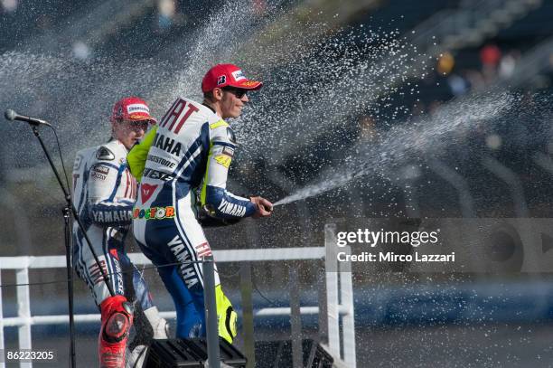 Jorge Lorenzo of Spain and Fiat Yamaha Team and Valentino Rossi of Italy and Fiat Yamaha Team celebrate and spray champagne on the podium after the...