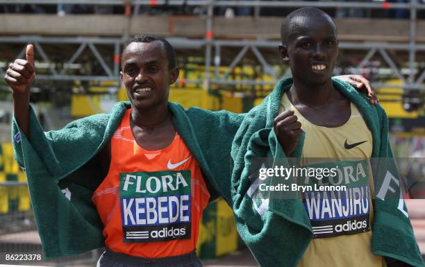 Tsegaye Kebede of Ethiopia poses with winner Samuel Wanjiru after the 2009 Flora London Marathon on April 26, 2009 in London, England.