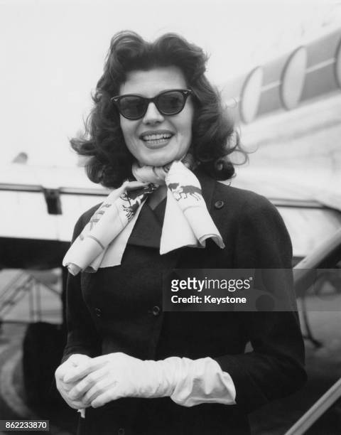 American actress Rita Hayworth flies back to Paris from London Airport, after a dress fitting for her new film 'Fire Down Below', 26th April 1956.