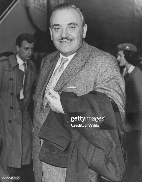 English bandleader Ted Heath arrives at London Airport after a tour of the United States, 12th November 1957.