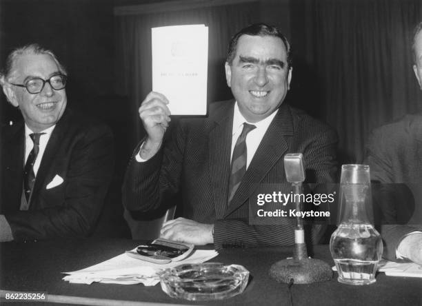 Denis Healey , the Secretary of State for Defence, holds up the 1966 Defence White Paper, a review of the UK defence policy, during a press...