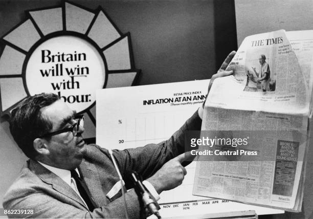 British Labour politician Denis Healey , the Chancellor of the Exchequer, holds up a copy of 'The Times' during a election campaign press conference...