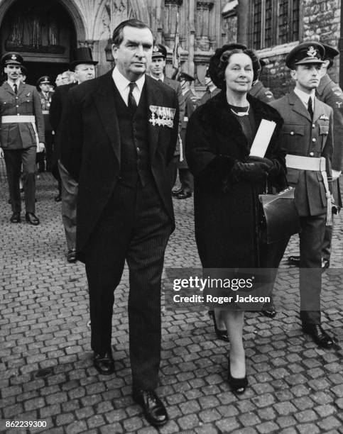 British politician Denis Healey , the Secretary of State for Defence, leaves Westminster Abbey in London with his wife Edna after attending a...