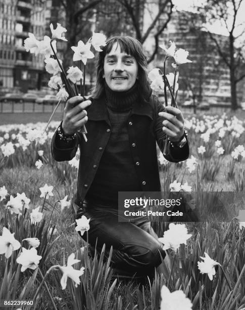 Disc jockey Stuart Henry poses amongst the daffodils in Hyde Park, London, after the announcement that he is to join Radio Luxembourg for the late...