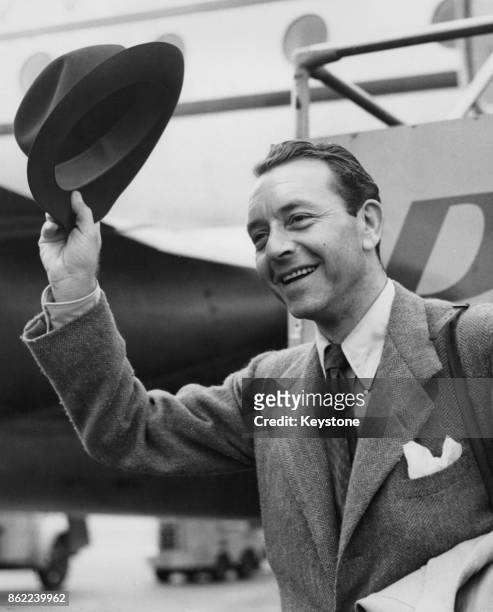Austrian-born American actor Paul Henreid arrives in London Airport to begin work on his next film, 12th June 1952.