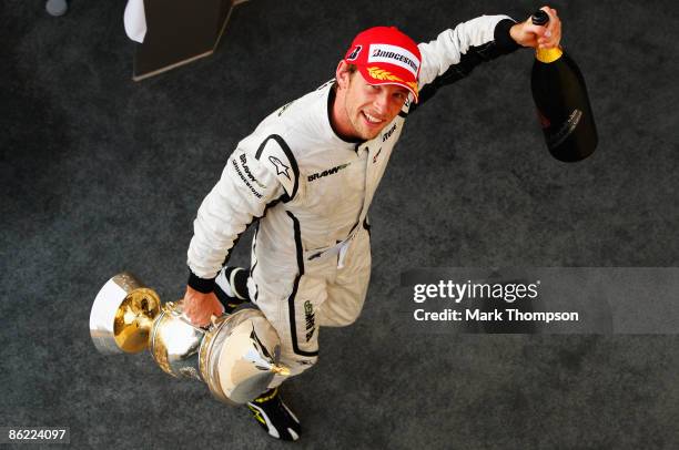 Jenson Button of Great Britain and Brawn GP celebrates on the podium after winning the Bahrain Formula One Grand Prix at the Bahrain International...