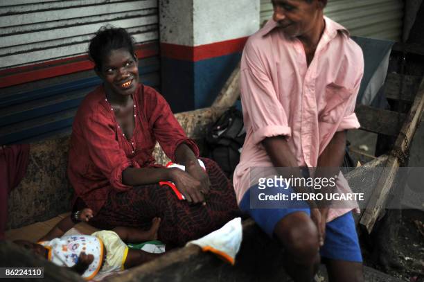 Poor Sri Lankan family uses a wooden chariot as a bed for their baby in Colombo on April 26, 2009. The central bank said beginning of April that...