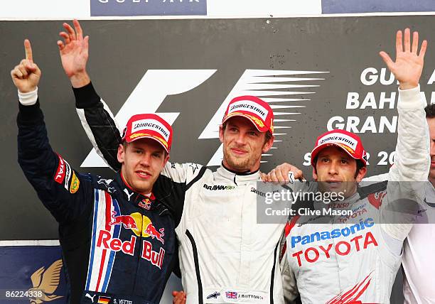 Race winner Jenson Button of Great Britain and Brawn GP, second placed Sebastian Vettel of Germany and Red Bull Racing and third placed Jarno Trulli...