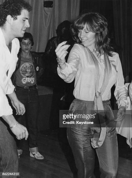 American actress Marilu Henner, the girlfriend of actor John Travolta, dancing at the Lyceum during an after-party for the UK premiere of 'Grease',...