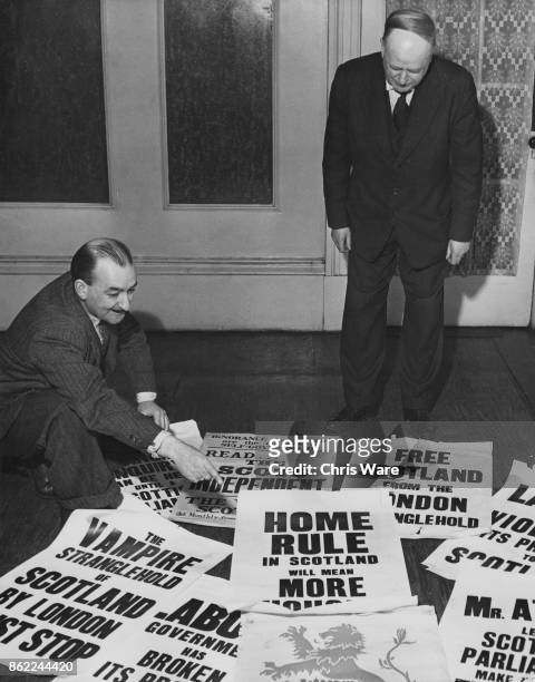 Blair Henderson shows Tom Gibson , President of the Scottish National Party, some of the new 'Home Rule for Scotland' posters at the SNP headquarters...