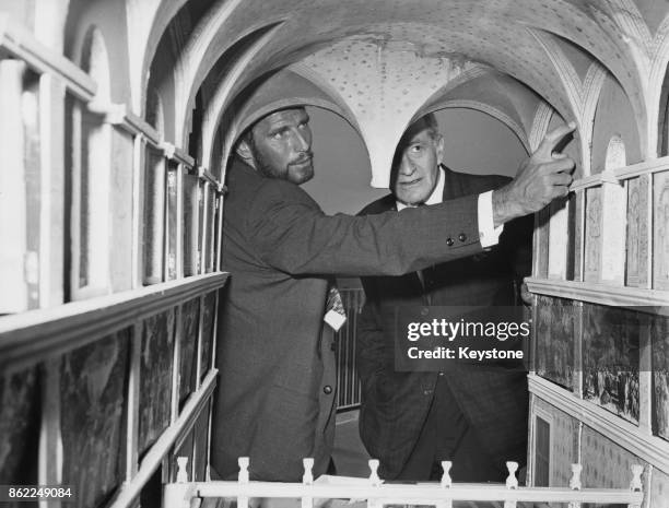 American actor Charlton Heston with a miniature set of the Sistine Chapel, during a press conference at the Hilton Hotel on the Carol Reed film 'The...