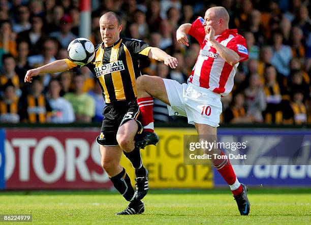 Paul Carden of Cambridge United battles for the ball with Chris Denham of Altrincham during the Blue Square Premier League Conference match between...