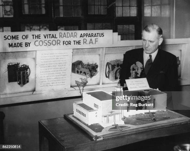 Conservative politician Harold Balfour, 1st Baron Balfour of Inchrye , examines a model of the proposed new chapel at Biggin Hill Aerodrome, after...