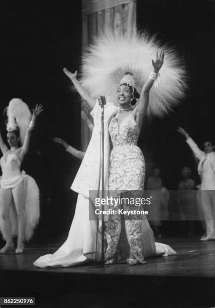 French entertainer Josephine Baker wears a headdress of 4,000 feathers for a rehearsal of her new revue 'Paris Mes Amours' at the Olympia Theatre in...