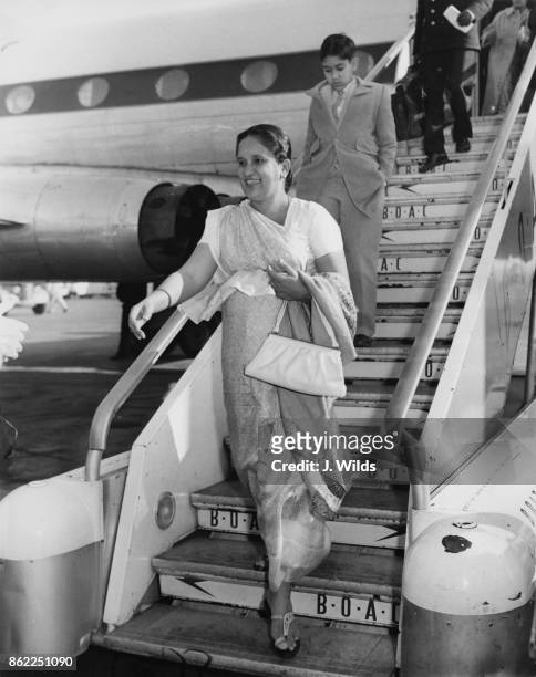 Sirimavo Bandaranaike , the Prime Minister of Ceylon , arrives at London Airport with her son Anura, to attend the Commonwealth Prime Ministers'...