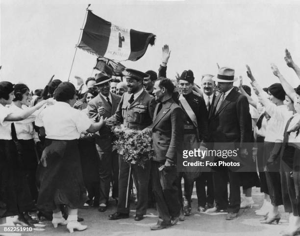General Italo Balbo is greeted by representatives of the Montreal Women's Fascist Organisation upon his arrival in Montreal, Canada, with the Italian...