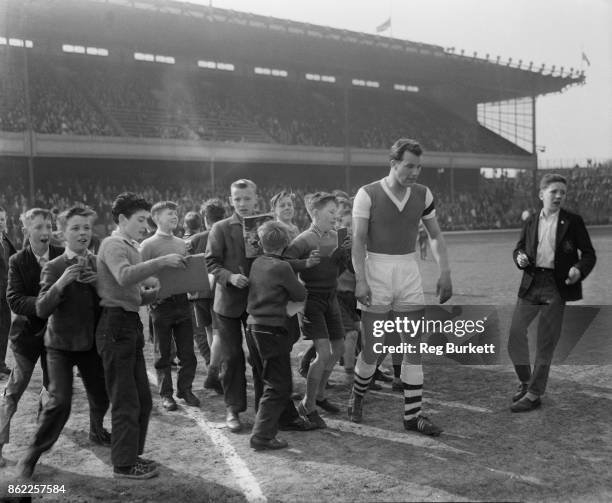 Welsh footballer Mel Charles is pursued by a crowd of young autograph hunters during his first game for Arsenal in the Reserves, against Charlton...