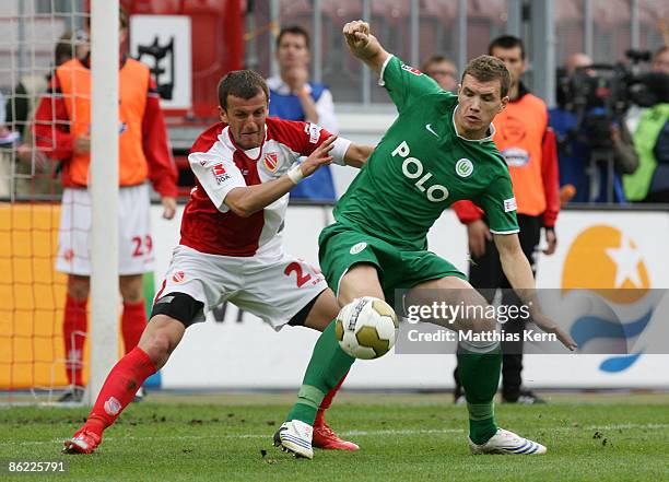 Ovidiu-Nicusor Burca of Cottbus battles for the ball with Edin Dzeko of Wolfsburg during the Bundesliga match between FC Energie Cottbus and VfL...