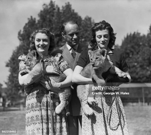 British actress Sarah Churchill , the daughter of Prime Minister Winston Churchill, with her husband, comedian Vic Oliver and Jane, one of the lions...