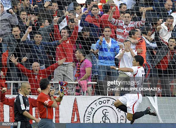 Sevilla's Brazilian midfielder Renato Dirnei jumps as he celebrates after scoring during the Spanish League football match against Real Madrid at the...