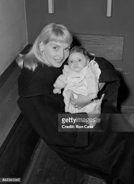 Australian actress Diane Cilento arrives at London Airport with her baby daughter Giovanna Volpe, 15th February 1958.
