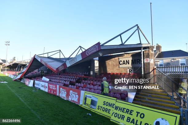 Workmen survey the damage to the roof of Turners Cross stadium, home to the Munster Football Association, and League of Ireland side Cork City, in...