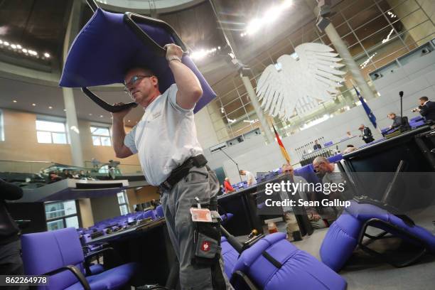 Workers install new seats and working spaces for parliamentarians in the Bundestag at the Reichstag on October 17, 2017 in Berlin, Germany. Following...